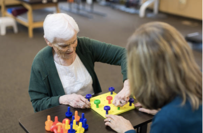 Therapist supporting client with activity